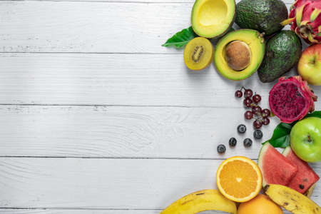 Fresh fruits background. Healthy food, Fresh organic fruits background. The concept of healthy dietary nutrition. Flat lay, top view with copy space.の写真素材
