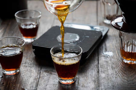 Coffee drip on the table, Drip brewing, filtered coffee, or pour-over is a method which involves pouring water over roasted, ground coffee beans contained in a filter. Breakfast concept.の写真素材