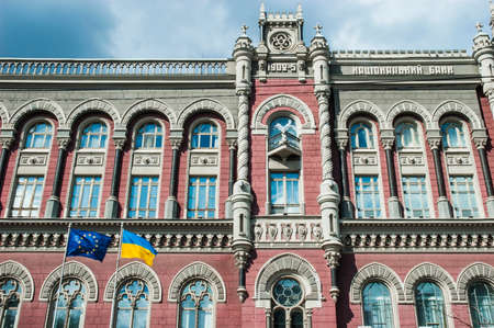 Kyiv / Ukraine - July 31, 2020: European Union and Ukrainian flags swaying in front of main beautiful building National Bank of Ukraineのeditorial素材