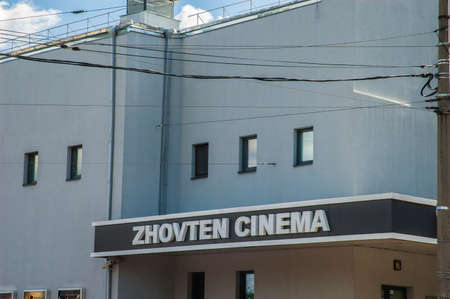 Kyiv / Ukraine - August 07, 2020: The "Zhovten cinema" large 3d black and white signboard on modest modernist facadeのeditorial素材