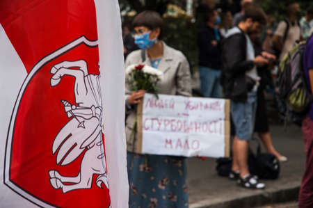 KYIV, UKRAINE - AUGUST 13, 2020: Women activists protest posters with inscription 'People are killed - anxiety is little' during the protests in support of Belarus near the Belarusian embassy in Kyivのeditorial素材