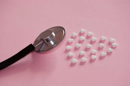 Stethoscope with heart shape pillsの写真素材
