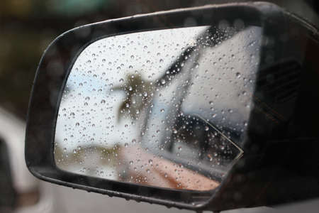 Rainy rain with rain on car glass background blurredの写真素材