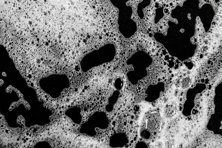 White soap bubbles on a black background