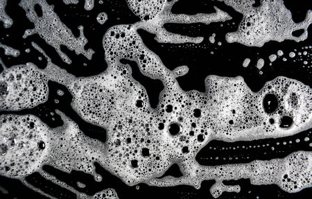 White soap bubbles on a black background