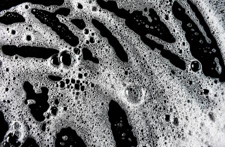 White soap bubbles on a black backgroundの写真素材