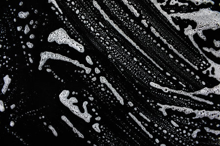 White soap bubbles on a black background