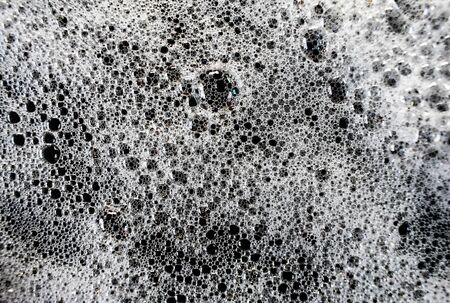White soap bubbles on a black backgroundの写真素材
