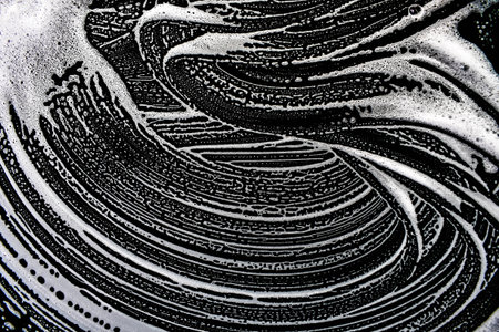 White soap bubbles on a black background