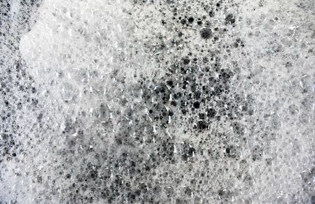 White soap bubbles on a black backgroundの写真素材