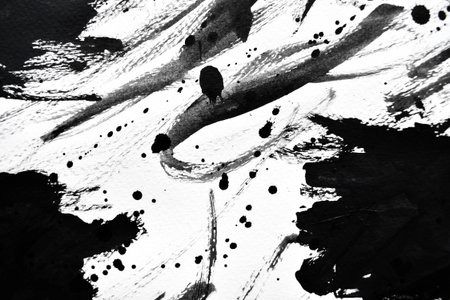 Black ink droplets on white paperの写真素材