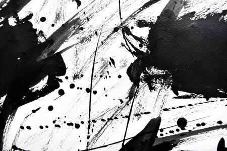 Black ink droplets on white paperの写真素材
