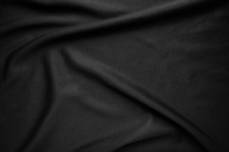 Background texture black cloth. Abstract dark wavy soft. Fabric is wrinkled. Fashion luxury style.の写真素材