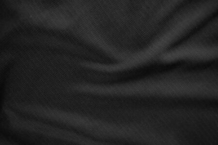 Background texture black cloth. Abstract dark wavy soft. Fabric is wrinkled. Fashion luxury style.の写真素材