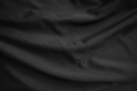 Background texture black cloth. Abstract dark wavy soft. Fabric is wrinkled. Fashion luxury style.の写真素材
