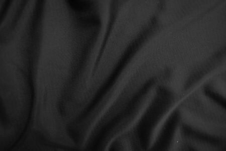 Background texture black cloth. Abstract dark wavy soft. Fabric is wrinkled. Fashion luxury style.の写真素材