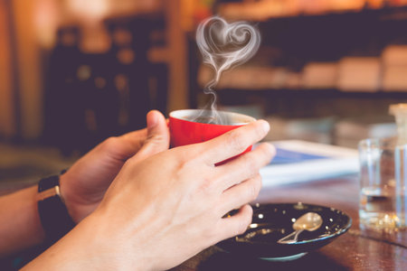 hot americano is served at a coffee shop, putting on the wooden table.の写真素材