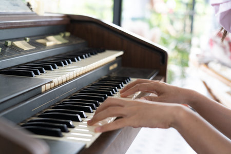 Female pianist hands on grand piano keyboard.
