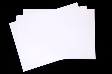 Blank notepad. Blank Paper on black background.Copy space