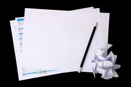 Blank notepad and spreadsheet with penceil. Blank Paper on black background.Copy space