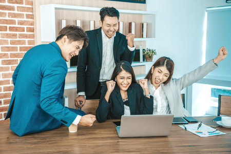 Young asian business people looking at screen during video conference in office