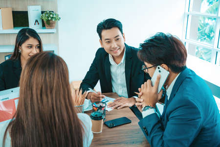 Happy diverse employees team working as teamwork success, business achievement at meeting. Group of successful happy business people working as a team in office on meeting.の写真素材