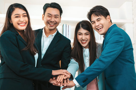 Happy diverse employees team celebrating teamwork success, business achievement at meeting.Group of...