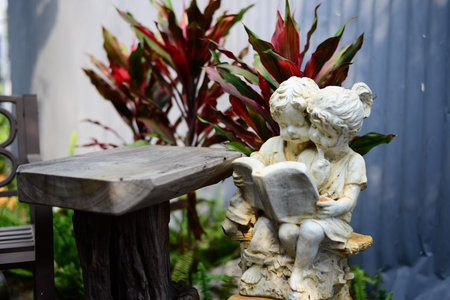 Statue of Girl and Boy reading the book in the gardenの写真素材