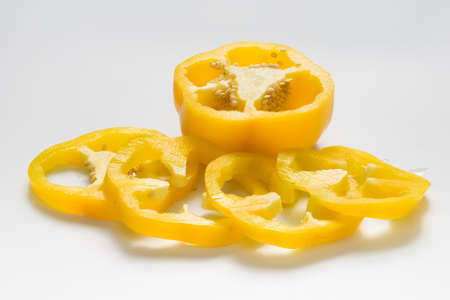 Yellow capsicum or sweet pepper slices on white backgroundの写真素材