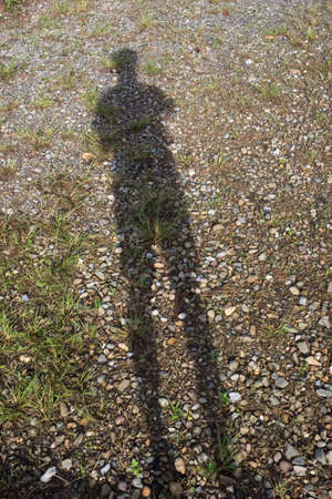 Man's shadow on the groundの写真素材