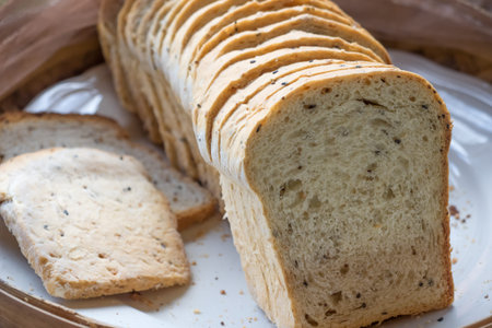 A loaf of whole wheat bread sliced for healthy breakfastの写真素材
