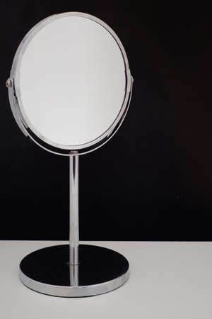 mirror on white table black backgroundの写真素材