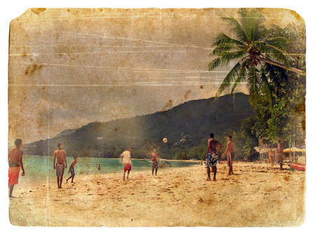 Young boys playing beach football on the island of Mahe, Seychelles, 2007. Designed in the style of an old postcardのeditorial素材