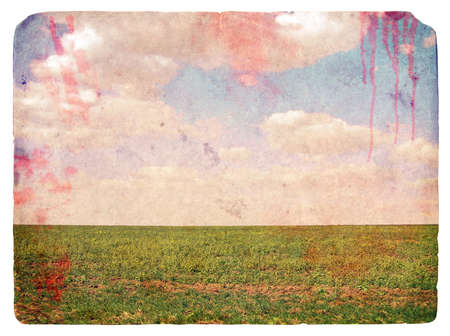 Grunge image of a field and sky with clouds and spots blood. Vintage backgroundの写真素材