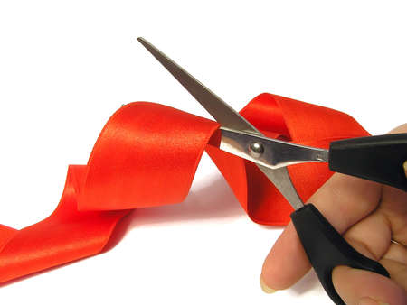 Red tape and scissors on a white background.      の写真素材