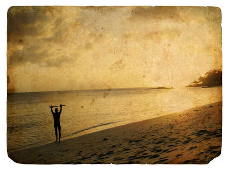  Silhouette of a man on the beach, sunset. Old postcard, design in grunge and retro styleの写真素材