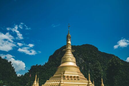 gold pagoda and mountain and blue sky background.の写真素材
