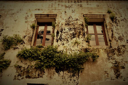 Old wall with window detail of an old building in ruinsの写真素材