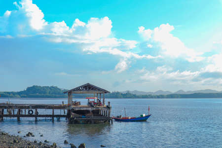 Wooden hut in the sea, the mountains and blue sky.の写真素材
