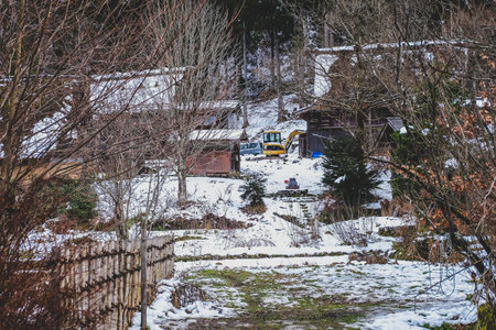 Scenery of a village and the road leading to it covered with snow during winter in Japan.の写真素材