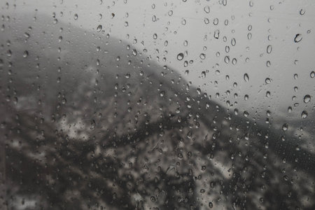 Raindrop on the window on a rainy day.