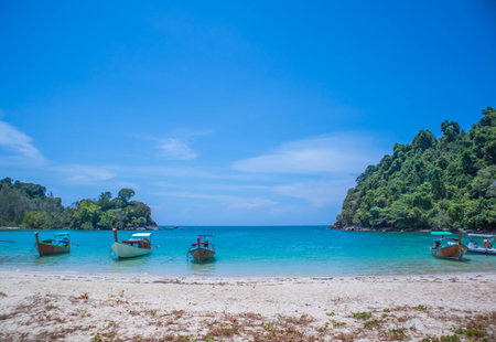 Beautiful sandy beach with long tail boats anchored on the beach of Koh Kamtok, Ranong Province, Thailand, Asiaの写真素材