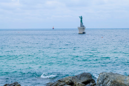 Small lighthouse tower in the sea near an island in the Caribbeanの写真素材