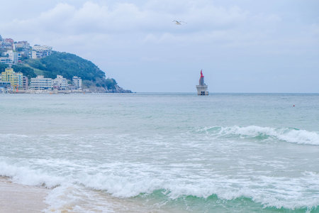 A scenic view of the sea on the background of mountains under a clear skyの写真素材