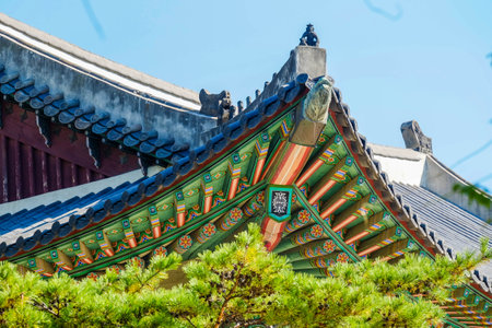 Detail of Traditional Korean Roof, Colourful Decorated Ornament for Ancient Korean Palace or Temple at Seoul, South Korea.の写真素材
