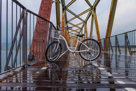 Steel and wooden bridge for pedestrians crossing over the railway tracksの写真素材