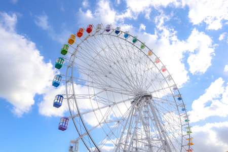 Colourful ferris wheel against a blue sky, Japanの写真素材