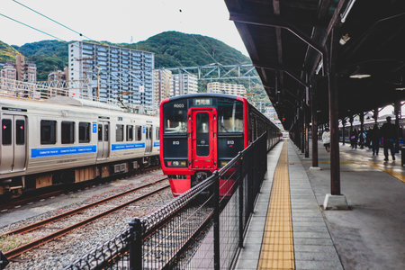 Commuter Train Waiting at a Japanese Railway Platformの写真素材