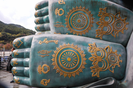 Intricate Golden Patterns on the Giant Buddha Sculptureの写真素材