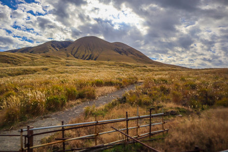 Kusasenri grass field and mountain with active volcanoes travelの写真素材